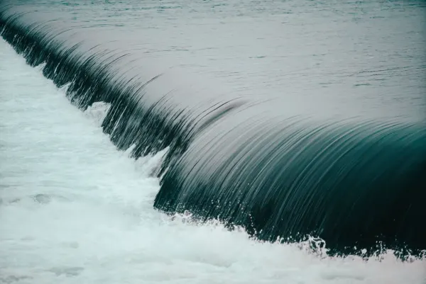 Water spilling over a weir into churning white water, monitored by Divako